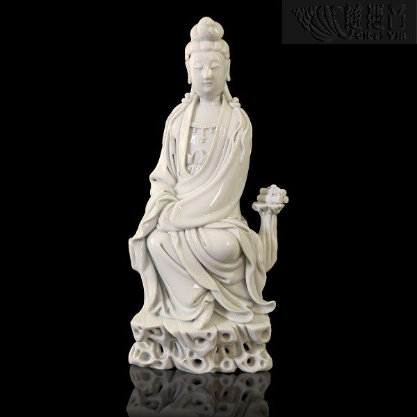 A Porcelain Figure Of A Seated Guanyin