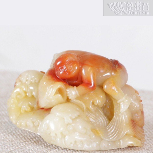 Shoushan stone carving of a child and fish ornament